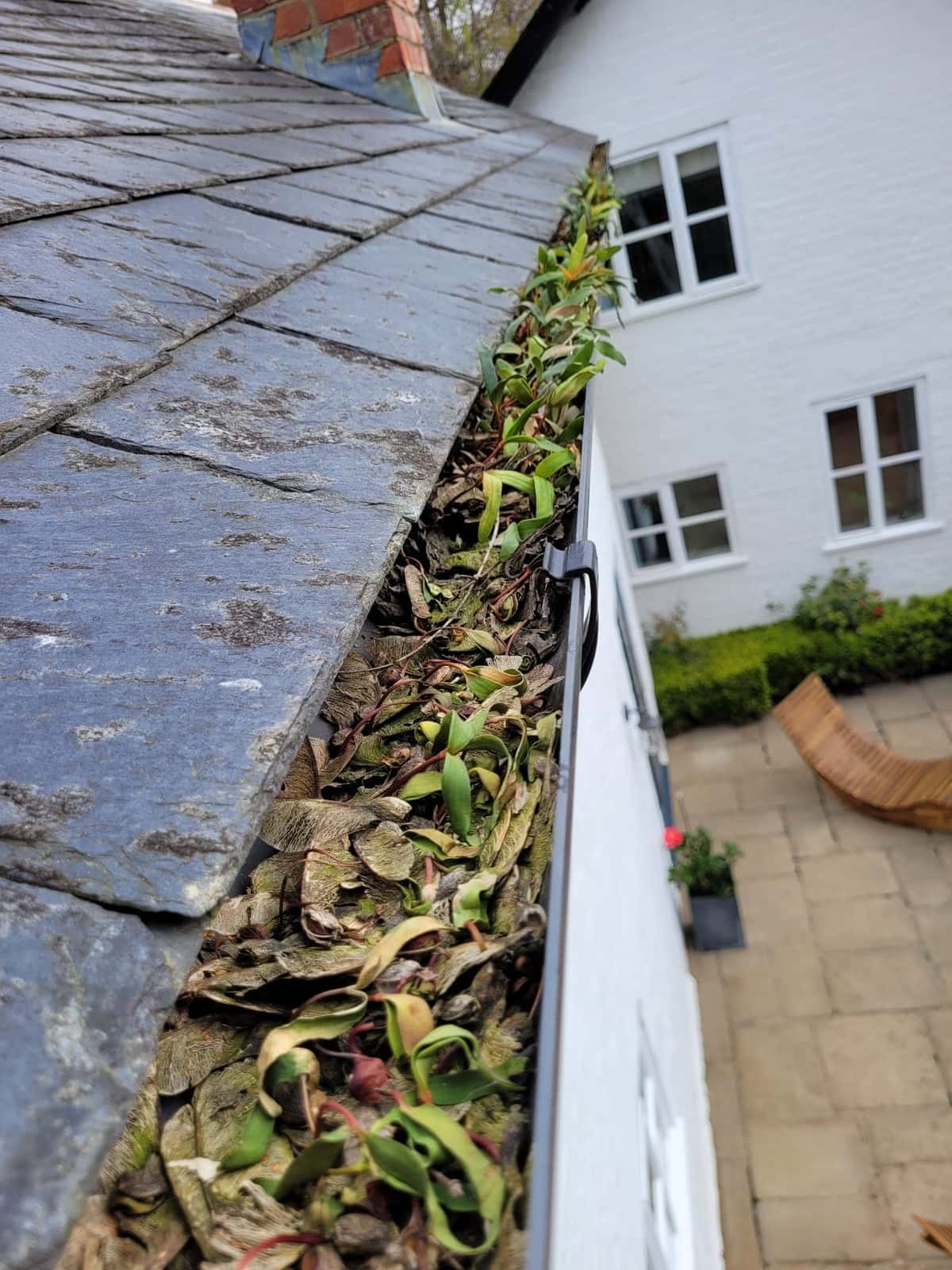 Water flowing freely through a cleared gutter and downpipe